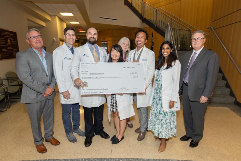 Kent County Levy Court recently presented a ceremonial check for $500,000 from the American Rescue Plan Act to Bayhealth’s GME program. Shown are (l-r) Bayhealth Inc. board Chair Gregg Moore; Bayhealth Internal Medicine Residency Program Director Dr. Joseph Deutsch; PGY-2 Family Medicine Resident Dr. Kendall Barton; PGY-2 Internal Medicine Resident Dr. Amanda Nguyen; GME Director Lori Smith; PGY-1 Family Medicine Resident Dr. Jonathan Ignacio; Bayhealth Family Medicine Residency Program Director Dr. Brintha Vasagar; and Bayhealth Foundation President Lindsay Rhodenbaugh. SUBMITTED PHOTO